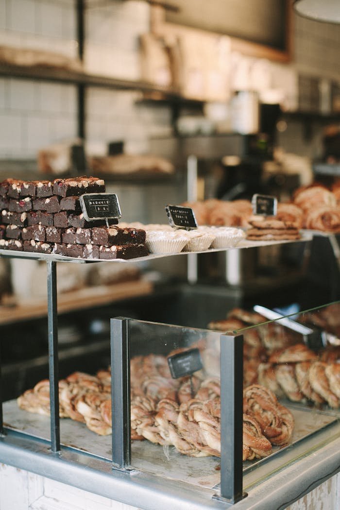 Delicious pastries and brownies displayed in a quaint English bakery. Perfect for sweet cravings.